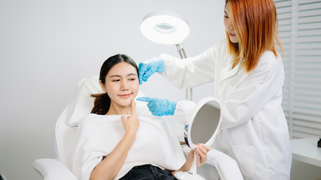 Provider consulting with a patient during a facial exam